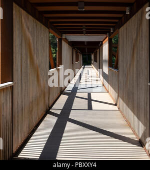 A covered wooden pedestrian and cyclist bridge in Norway Stock Photo