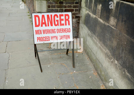 Danger - Men Working Overhead - Proceed with Caution side on pavement Stock Photo