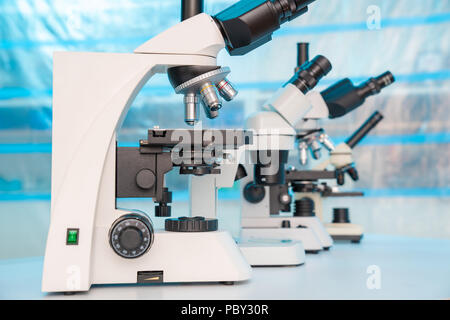 Four microscopes of different designs in the laboratory Stock Photo