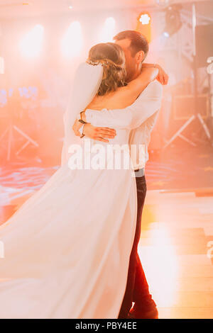 The groom is swaying the bride during the dance. Stock Photo