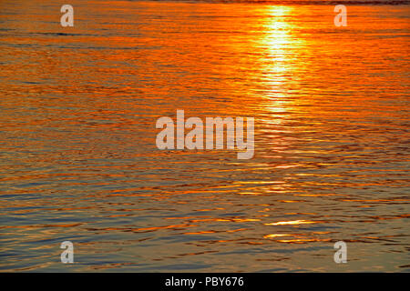 Setting sun reflected in the MacKenzie River, Fort Providence, Northwest Territories, Canada Stock Photo