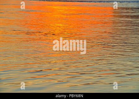 Setting sun reflected in the MacKenzie River, Fort Providence, Northwest Territories, Canada Stock Photo