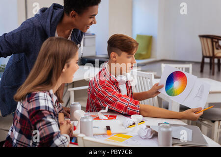 Promising creative art students looking at color palette Stock Photo