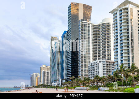 Sunny Isles Beach, USA - May 7, 2018: Apartment condo hotel modern building balconies during sunny day in Miami, Florida with skyscrapers urban exteri Stock Photo
