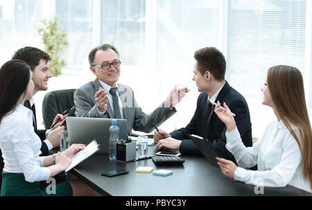 Manager and business group discussing financial documents Stock Photo