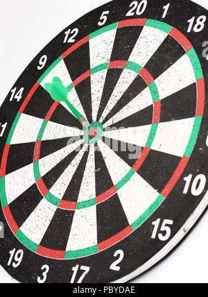 Arrow dart hitting the center of the target dart Board Stock Photo