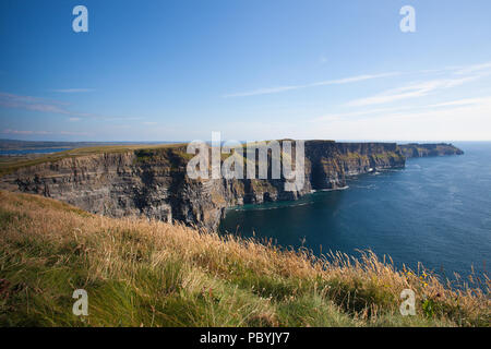 The famous Cliffs of Moher are sea cliffs located at the southwestern edge of the Burren region in County Clare, Ireland. They run for about 14 kilome Stock Photo