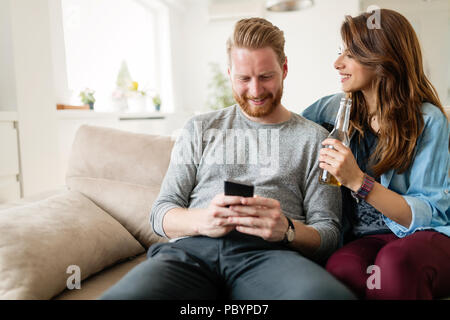 Young fashion couple of lovers playing with mobile Stock Photo