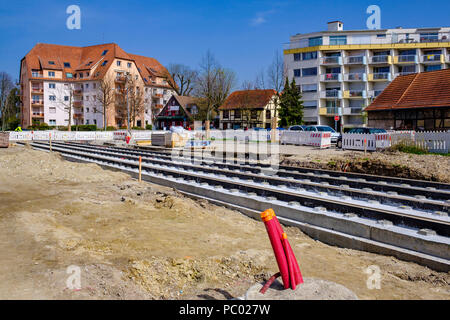 Strasbourg, tram construction site, railway tracks, concrete bed, red power outlets, houses, line E extension, Alsace, France, Europe, Stock Photo