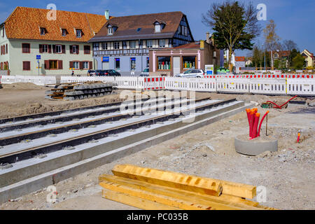 Strasbourg, tram construction site, railway tracks, concrete bed, red power outlets, houses, line E extension, Alsace, France, Europe, Stock Photo