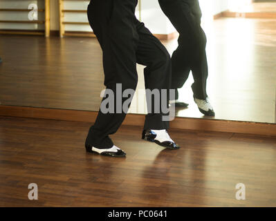 Male ballroom dance salsa dancer instructors man dancing in shcool rehearsal room Stock Photo