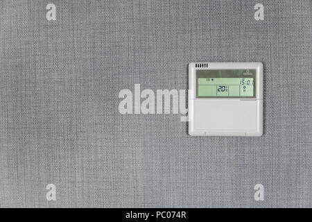 Wall display shows air temperature inside the apartment room. Smart home automation. Showing household consumptions related to temperature and heating. Stock Photo