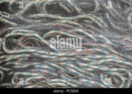 Ropes for catching fish rolled up in a fishing net, texture. Stock Photo