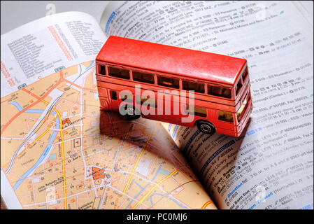 Miniature English red routemaster double decker bus on Michelin red guide, Stock Photo