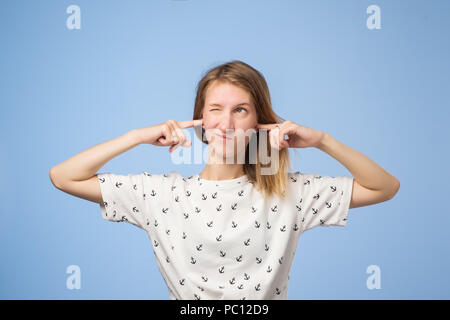 Portrait of funny european woman plugging ears, closing her eyes, pretending not to hear wat she is told Stock Photo