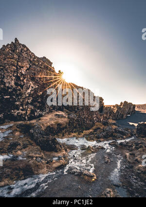 Djupalonssandur sun star or the Black Lava Pearl Beach on the Snaefellsnes peninsula in Iceland. Stock Photo
