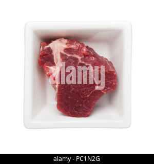 Piece of beef tenderloin in a square bowl isolated on white background Stock Photo