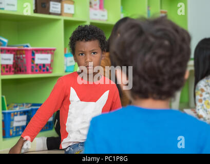 African american boy angry and looking at friend in school library in kindergarten.kids education concept Stock Photo