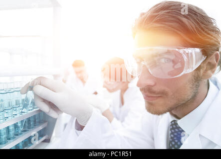 man in goggles to check fluid in vitro. Stock Photo