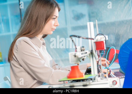 A young woman design a model of an artificial organ on a 3D printer Stock Photo