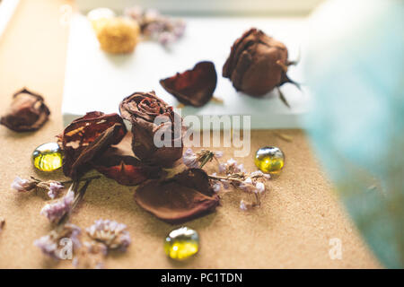 Defocused love and withered rose on white book and retro grasses and vintage mint green typewriter in background, love forever, memory concept Stock Photo