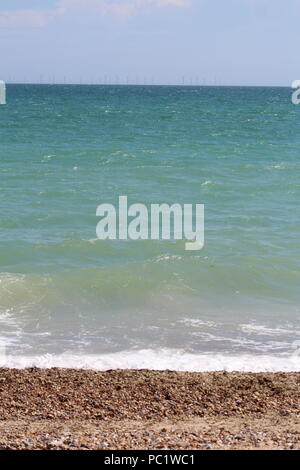 Tide coming in over pebbled beach in Goring-by-sea Stock Photo