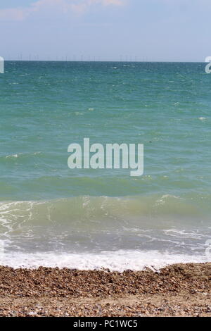 Tide coming in over pebbled beach in Goring-by-sea Stock Photo