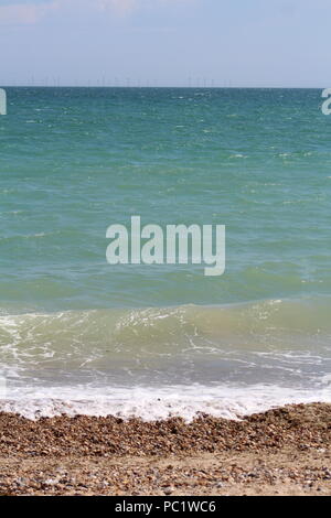 Tide coming in over pebbled beach in Goring-by-sea Stock Photo