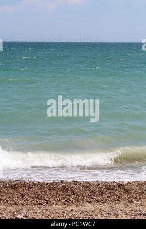 Tide coming in over pebbled beach in Goring-by-sea Stock Photo