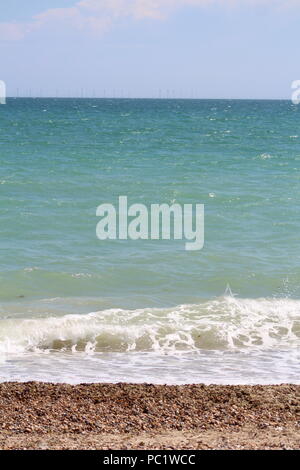 Tide coming in over pebbled beach in Goring-by-sea Stock Photo