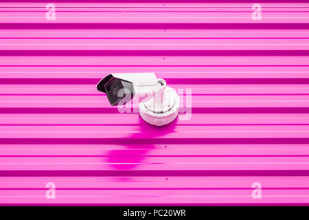 Security camera on pink wall minimal creative concept. Stock Photo