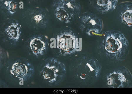 Flat-lay of wet dark forest blueberries, top view, horizontal composition Stock Photo
