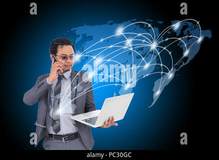 business man talking on mobile phone and using laptop with world map for social and internet connectivity concept Stock Photo