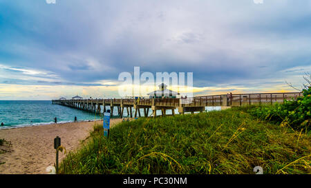 Juno Beach Pier before an impending storm Stock Photo