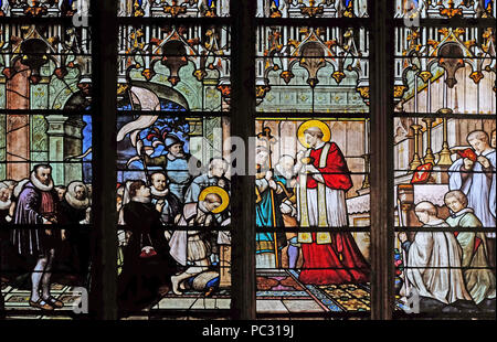 St. Aloysius Gonzaga receiving first communion from the hands of Saint Charles Borromeo, stained glass window in Saint Severin church in Paris, France Stock Photo