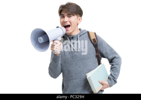 Cheerful male college student shouting through megaphone Stock Photo