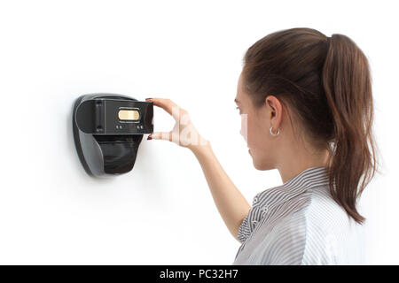 Woman looking at eye recognition device Stock Photo