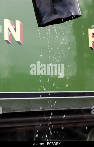 Water dripping from a pipe following the re watering of the engine. Stock Photo