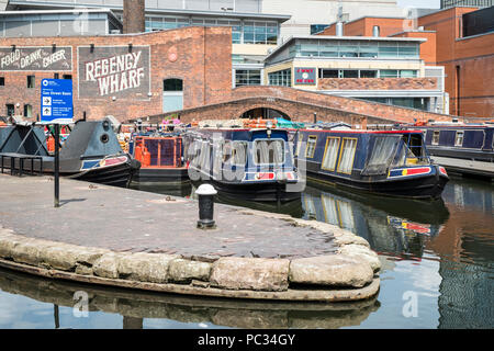 Moored narrowboats at Regency Wharf, Gas Street Basin in Birmingham city centre, England, UK. Stock Photo