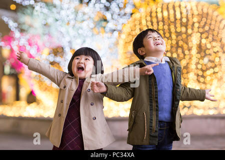 Cheerful Chinese children playing outdoors Stock Photo