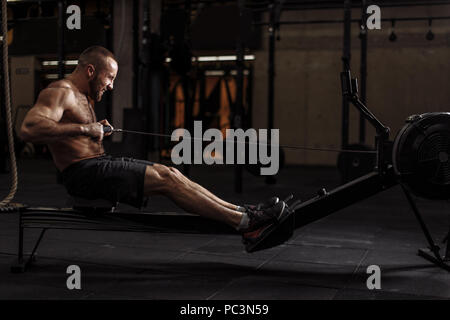 difficult workout in the sport center.athlete with closed eyes doing his best while trainingperseverance and tenacity concept Stock Photo