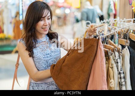 young woman shopping in a clothing store Stock Photo