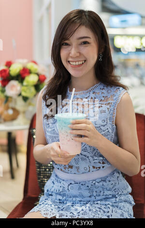 woman drinking a cup of milk at a cafe Stock Photo