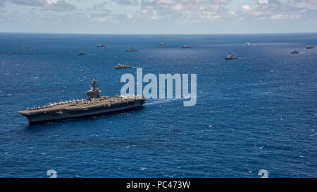 180726-N-MT837-0230  PACIFIC OCEAN (July 26, 2018) International navy ships assemble for a photo exercise off the coast of Hawaii during the 2018 Rim of the Pacific (RIMPAC) exercise, July 26, 2018. Twenty-five nations, more than 45 ships and submarines, about 200 aircraft, and 25,000 personnel are participating in RIMPAC from June 27 to Aug. 2 in and around the Hawaiian Islands and Southern California. The world's largest international maritime exercise, RIMPAC provides a unique training opportunity while fostering and sustaining cooperative relationships between participants critical to ensu Stock Photo