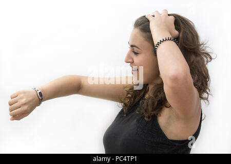 Stressed woman on white backround looking at the clock Stock Photo