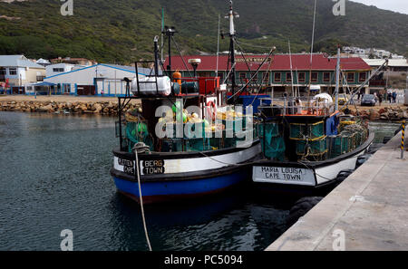 Fishing trawlers with crayfish pots on deck in the Hout Bay harbour near Cape Town, South Africa. Stock Photo