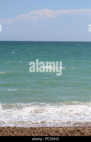 Tide coming in over a pebbled beach Stock Photo