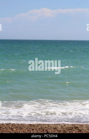 Tide coming in over a pebbled beach Stock Photo