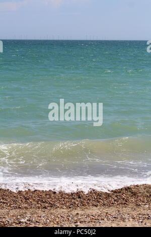 Tide coming in over a pebbled beach Stock Photo