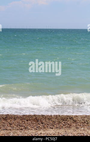 Tide coming in over a pebbled beach Stock Photo